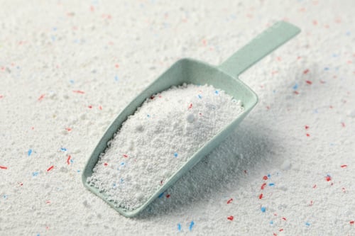 Preview: Scoop with washing powder on washing powder background