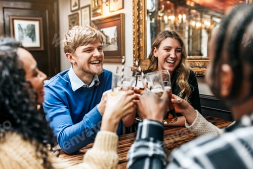 Preview: Happy people enjoying drinks in pub