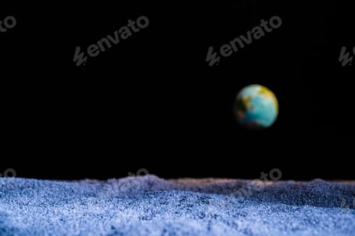 Preview: textured ground with blurred planet Earth in space isolated on black