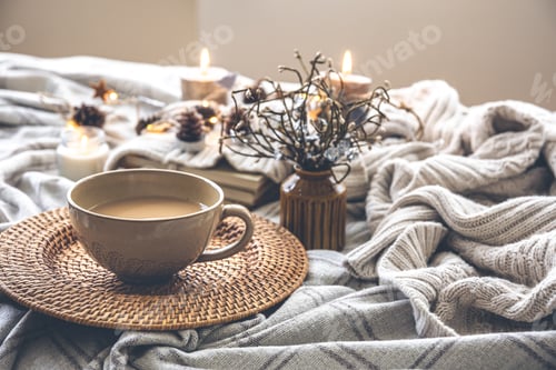 Preview: Cozy autumn composition with a big cup of coffee in bed.