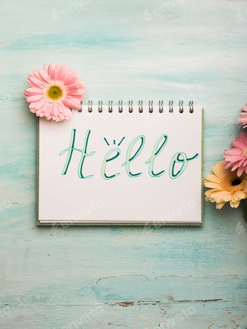 Preview: Hello word written on notebook page. Flowers