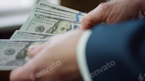 Preview: Banker hands counting american currency denomination of hundred dollars close up