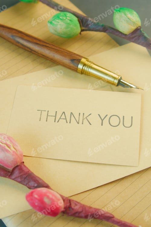 Preview: thank you message and envelope on wooden table
