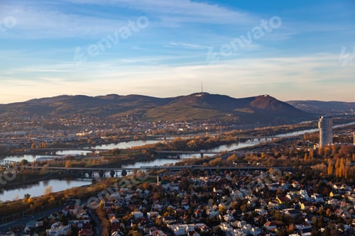 Preview: Vienna's Bridge over Tranquil River Amidst Fall Foliage