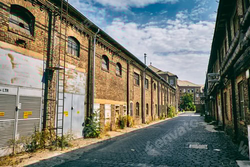 Cobblestone Street Between Old Brick Industrial Buildings