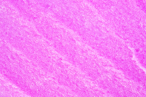 Preview: Texture of raspberry salt scrub, closeup. Smudges and strokes with salt particles.