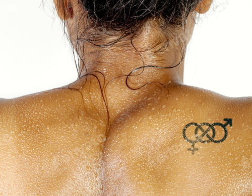 Preview: Transsexual movement symbol tattoo on the back of wet woman body