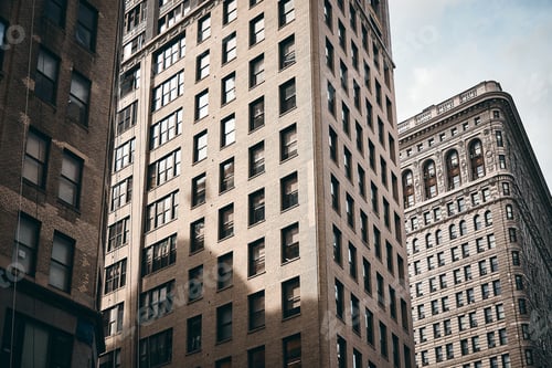 Preview: Flatiron building of Manhattan, New York City against the cloudy sky