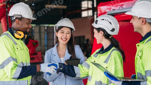 Preview: A group of construction workers are shaking hands with a woman in a suit
