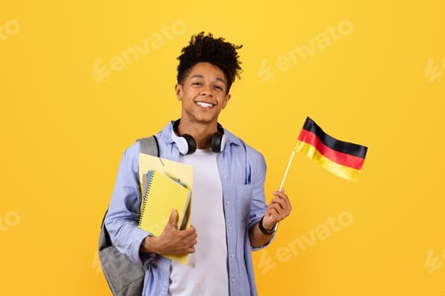 Preview: Cheerful black man student with German flag and books