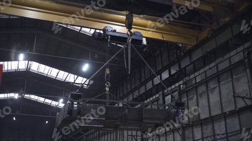 Preview: Frame of train on plant. Clip. Platform with train wheels is suspended on chains in factory. Frame