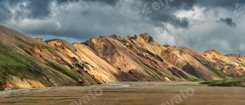 Preview: Panoramic view of the colorful rhyolite mountains in Landmannalaugar, Iceland, under cloudy skies.