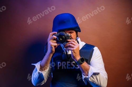 Preview: Reporter in bulletproof vest with a camera.