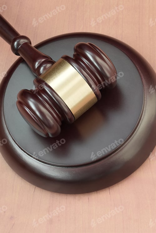 Preview: Justice mallet on wooden desk in a courtroom during a judicial trial. Law concept and empty space f