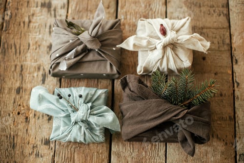 Preview: Zero waste gifts flat lay. Furoshiki eco friendly simple presents. Stylish christmas gifts in fabric