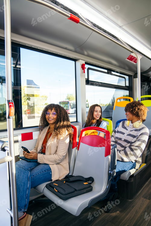 Preview: Young diverse women commuting on public city bus