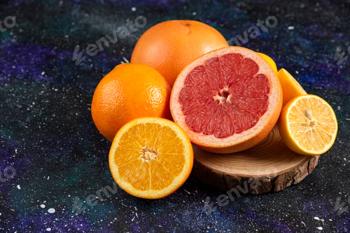 Preview: Fresh citrus fruits on wooden board. Whole or half cut