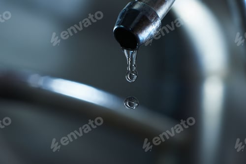 Preview: Reverse osmosis filter tap closeup with dripping water-drop.