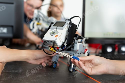 Preview: Children play with a robot dog in a robotics lesson