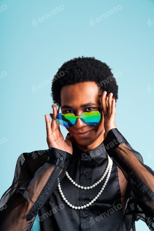 Preview: Fashionable fluid gender man posing in studio