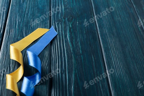 Preview: Ribbons in Ukrainian flag colors on wooden background