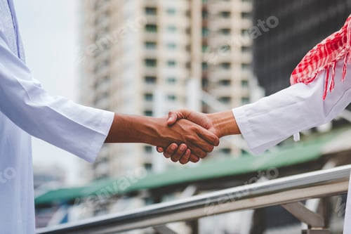 Preview: Arab Businessman shaking hands together. Teamwork business partner wear Muslim dress Shake Hands