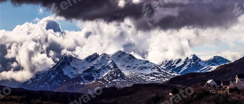 Preview: Scenic landscape featuring snowy mountains under a dramatic sky in Isle of Skye, Scotland, UK