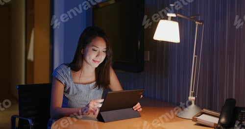 Preview: Woman work on tablet computer at home