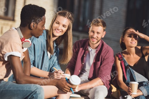 Preview: group of happy students spending time together and drinking coffee