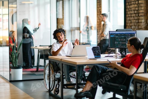 Preview: A young business group, including an African American businessman in a wheelchair, collaborates