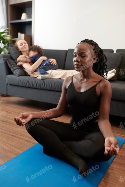 Preview: Woman Meditating on Yoga Mat