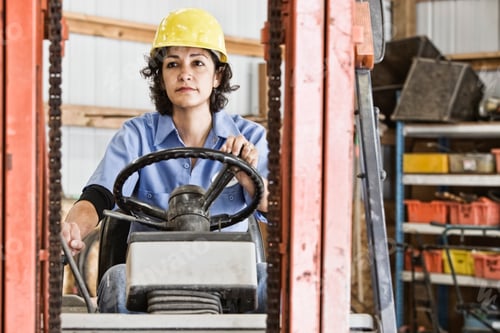 Preview: Hispanic woman employee using a forklift in a landscape company.