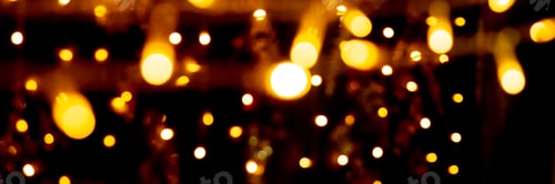 Preview: Blurry garland lights on a dark background. Festive Christmas and New Year background. Soft focus