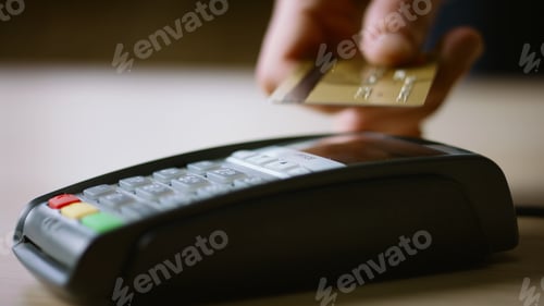 Preview: Contactless credit card payment on bank terminal close up. Hand paying with NFC.