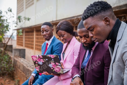 Preview: Four African business people during a meeting work discussing and using the laptop