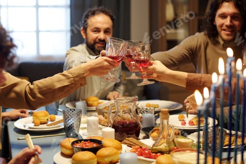 Preview: Hands of Jewish family members clinking with glasses of red wine