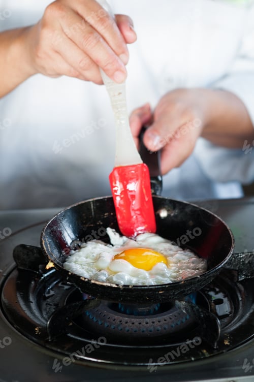 Preview: Chef cooking fried egg on frying pan