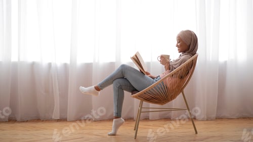 Preview: Woman Relaxes at Home Reading a Book