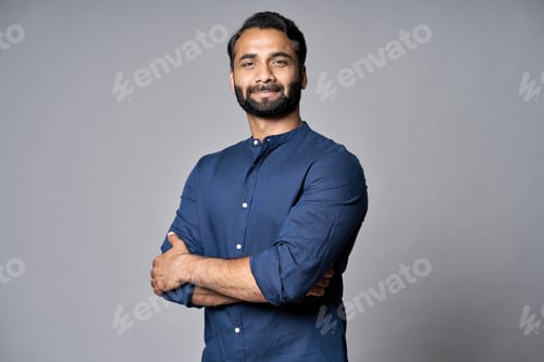 Preview: Proud confident indian business man isolated on gray, headshot portrait.