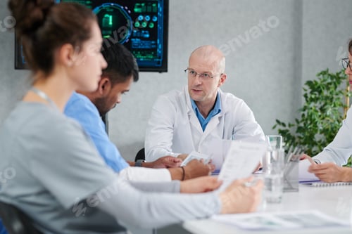 Preview: Group of doctors sitting at meeting