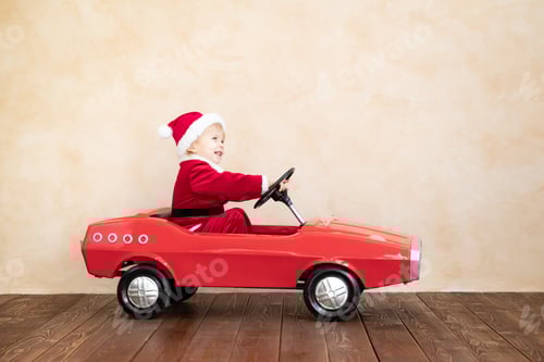 Preview: Adorable Child Dressed as Santa Driving Toy Car