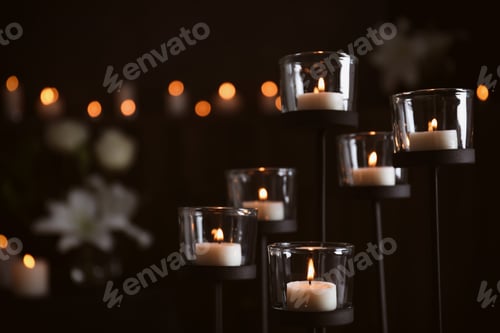 Preview: Burning candles on blurred background, space for text. Funeral symbol