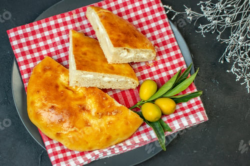 Preview: Top view of delicious bread kumquats with stem on dark background