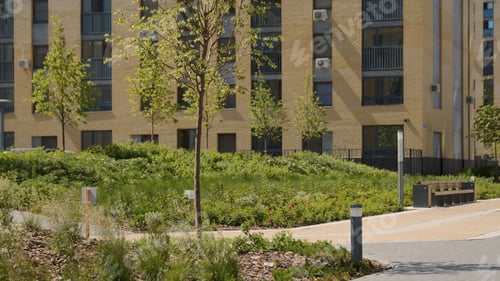 Preview: A large high-rise building.Stock footage.A bright yellow brick house that is taken from top to