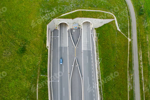 Preview: Top view on the tunnel entrance of highway covered with green grass