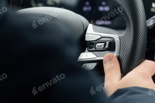 Preview: Driver thumb adjusts steering wheel media controls to keep eyes on road