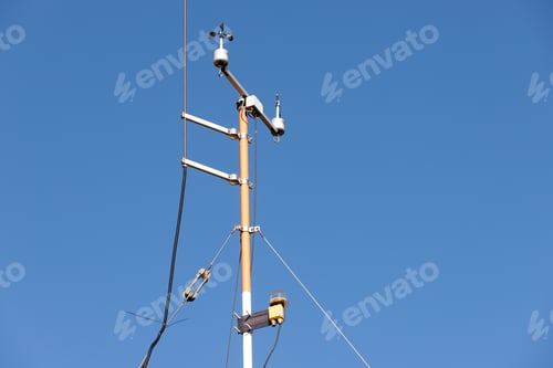 Preview: Close-up weather station wind speed direction measurement sensor gauge anemometer against clear blue