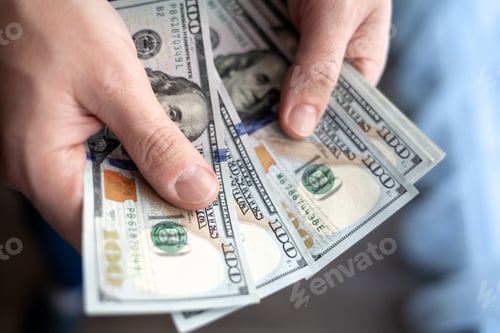 Preview: Close up male hand Counting and holding money us dollar.