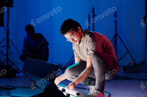 Preview: Man setting the light for shooting