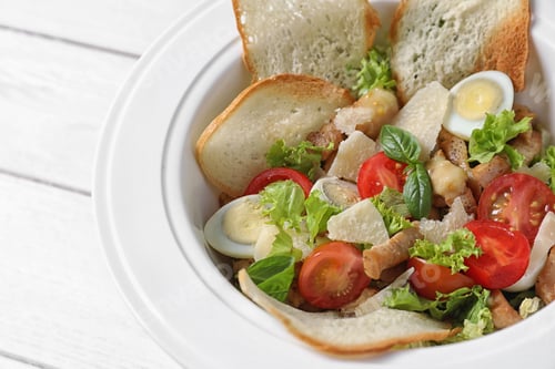 Preview: Plate with delicious fresh salad on table, closeup